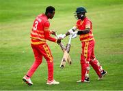 6 September 2021; Tinashe Kamunhukamwe of Zimbabwe XI, right, gets a replacement bat from team-mate Milton Shumba during the one day match between Ireland Wolves and Zimbabwe XI at Belmont Park in Belfast. Photo by Piaras Ó Mídheach/Sportsfile