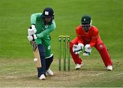 6 September 2021; Murray Commins of Ireland Wolves bats, watched by Zimbabwe XI wicketkeeper Regis Chakabva, during the one day match between Ireland Wolves and Zimbabwe XI at Belmont Park in Belfast. Photo by Piaras Ó Mídheach/Sportsfile