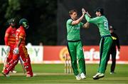 8 September 2021; Craig Young of Ireland, left, is congratulated by team-mate George Dockrell after claiming the wicket of Zimbabwe's Regis Chakabva during match one of the Dafanews International Cup ODI series between Ireland and Zimbabwe at Stormont in Belfast. Photo by Seb Daly/Sportsfile