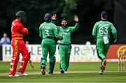 8 September 2021; Simi Singh of Ireland, centre, celebrates with team-mates Lorcan Tucker, left, and Andrew Balbirnie, right, after claiming the wicket of Zimbabwe's Brendan Taylor during match one of the Dafanews International Cup ODI series between Ireland and Zimbabwe at Stormont in Belfast. Photo by Seb Daly/Sportsfile