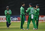 8 September 2021; George Dockrell, centre, and Andrew Balbirnie of Ireland, second from right, congratulated each other after claiming the wicket of Zimbabwe's Craig Ervine during match one of the Dafanews International Cup ODI series between Ireland and Zimbabwe at Stormont in Belfast. Photo by Seb Daly/Sportsfile