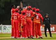 8 September 2021; Blessing Muzarabani of Zimbabwe, left, is congratulated by team-mates after claiming the wicket of Ireland's George Dockrell during match one of the Dafanews International Cup ODI series between Ireland and Zimbabwe at Stormont in Belfast. Photo by Seb Daly/Sportsfile