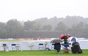 10 September 2021; Spectators await the resumption of play during heavy rain during match two of the Dafanews International Cup ODI series between Ireland and Zimbabwe at Stormont in Belfast. Photo by Ramsey Cardy/Sportsfile