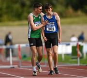 11 September 2021; Sean Carmody of Munster is consoled by Kieran Cooper of Leinster after falling at the last hurdle after leading the Boy's 400 metre Hurdles during the Irish Life Health Tailteann Schools' Inter-provincial Games at Morton Stadium in Santry, Dublin. Photo by Harry Murphy/Sportsfile