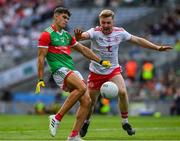 11 September 2021; Tommy Conroy of Mayo shoots past Michael O’Neill of Tyrone to score a point after 15 seconds during the GAA Football All-Ireland Senior Championship Final match between Mayo and Tyrone at Croke Park in Dublin. Photo by Ray McManus/Sportsfile