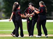 11 September 2021; Clíona Tucker, second from left, is congratulated by her Pembroke team-mates after taking the wicket of Jemma Rankin of Bready during the Clear Currency Women’s All-Ireland T20 Cup Final match between Bready cricket club and Pembroke cricket club at Bready Cricket Club in Tyrone. Photo by Ben McShane/Sportsfile