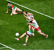 11 September 2021; Kevin McLoughlin of Mayo scores a point despite the efforts of Hugh Pat McGeary, left, and Frank Burns of Tyrone during the GAA Football All-Ireland Senior Championship Final match between Mayo and Tyrone at Croke Park in Dublin. Photo by Daire Brennan/Sportsfile