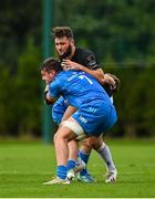 11 September 2021; Ben Carson of Ulster is tackled by Fionn O’Hara, behind, and during the Development Interprovincial match between Leinster XV and Ulster XV at the IRFU High Performance Centre, on the Sport Ireland Campus in Dublin. Photo by Seb Daly/Sportsfile