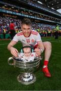 11 September 2021; Jonathan Monroe of Tyrone celebrates with his 5-and-half month old son Jona Joseph following the GAA Football All-Ireland Senior Championship Final match between Mayo and Tyrone at Croke Park in Dublin. Photo by Stephen McCarthy/Sportsfile