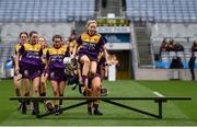 12 September 2021; Ciara Donohoe of Wexford jumps the bench for the team photograph before the All-Ireland Premier Junior Camogie Championship Final match between Armagh and Wexford at Croke Park in Dublin. Photo by Ben McShane/Sportsfile