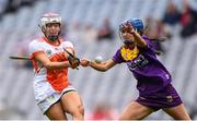 12 September 2021; Eimear Smyth of Armagh scores her side's first goal despite the attention of Clodagh Jackman of Wexford during the All-Ireland Premier Junior Camogie Championship Final match between Armagh and Wexford at Croke Park in Dublin. Photo by Ben McShane/Sportsfile