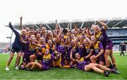12 September 2021; Wexford players celebrate with The Kathleen Mills Cup after the All-Ireland Premier Junior Camogie Championship Final match between Armagh and Wexford at Croke Park in Dublin. Photo by Ben McShane/Sportsfile