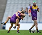 12 September 2021; Wexford players Aoife McCrea, 21, Aoife Dunne, behind, and Lara O'Shea, right, celebrate after their side's victory in the All-Ireland Premier Junior Camogie Championship Final match between Armagh and Wexford at Croke Park in Dublin. Photo by Piaras Ó Mídheach/Sportsfile