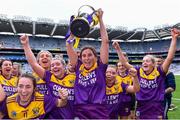 12 September 2021; Aisling Halligan of Wexford, centre, holds the cup aloft after her side's victory in the All-Ireland Premier Junior Camogie Championship Final match between Armagh and Wexford at Croke Park in Dublin. Photo by Piaras Ó Mídheach/Sportsfile