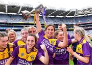 12 September 2021; Aisling Halligan of Wexford, centre, holds the cup aloft after her side's victory in the All-Ireland Premier Junior Camogie Championship Final match between Armagh and Wexford at Croke Park in Dublin. Photo by Piaras Ó Mídheach/Sportsfile