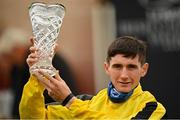 12 September 2021; Jockey Ben Coen with the trophy after riding Sonnyboyliston to victory in the Comer Group International Irish St. Leger during day two of the Longines Irish Champions Weekend at The Curragh Racecourse in Kildare. Photo by Seb Daly/Sportsfile