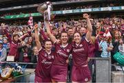 12 September 2021; Galway players, from left, Aoife Donoghue, Niamh Hannify and Catriona Cormican celebrate with The O'Duffy Cup and the supporters after their victory in the All-Ireland Senior Camogie Championship Final match between Cork and Galway at Croke Park in Dublin. Photo by Ben McShane/Sportsfile