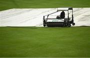 13 September 2021; A groundsman removes water from the covers before match three of the Dafanews International Cup ODI series between Ireland and Zimbabwe at Stormont in Belfast. Photo by Seb Daly/Sportsfile