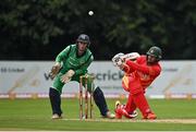13 September 2021; Craig Ervine of Zimbabwe plays a shot, watched by Ireland wicketkeeper Lorcan Tucker, during match three of the Dafanews International Cup ODI series between Ireland and Zimbabwe at Stormont in Belfast. Photo by Seb Daly/Sportsfile