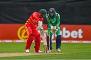 13 September 2021; Sean Williams of Zimbabwe is bowled by Ireland's Andrew McBrine, watched by Ireland wicketkeeper Lorcan Tucker, during match three of the Dafanews International Cup ODI series between Ireland and Zimbabwe at Stormont in Belfast. Photo by Seb Daly/Sportsfile