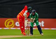 13 September 2021; Ryan Burl of Zimbabwe, and Ireland wicketkeeper Lorcan Tucker, during match three of the Dafanews International Cup ODI series between Ireland and Zimbabwe at Stormont in Belfast. Photo by Seb Daly/Sportsfile