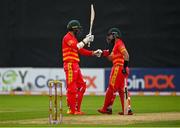 13 September 2021; Craig Ervine of Zimbabwe, left, is congratulated by team-mate Sikandar Raza after bringing up his half-century during match three of the Dafanews International Cup ODI series between Ireland and Zimbabwe at Stormont in Belfast. Photo by Seb Daly/Sportsfile