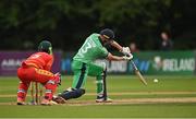 13 September 2021; Harry Tector of Ireland plays a shot, watched by Zimbabwe wicketkeeper Regis Chakabva, during match three of the Dafanews International Cup ODI series between Ireland and Zimbabwe at Stormont in Belfast. Photo by Seb Daly/Sportsfile
