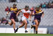 12 September 2021; Ciara Donnelly of Armagh and Megan Cullen, left, and Roisin Cooney of Wexford during the All-Ireland Premier Junior Camogie Championship Final match between Armagh and Wexford at Croke Park in Dublin. Photo by Ben McShane/Sportsfile