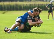 18 September 2021; Peter Sullivan of Connacht dives over to score his side's sixth try, despite the tackle of Leinster's Dylan Ryan, during the Development Interprovincial match between Leinster XV and Connacht XV at the IRFU High Performance Centre, on the Sport Ireland Campus in Dublin. Photo by Seb Daly/Sportsfile