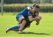 18 September 2021; Peter Sullivan of Connacht dives over to score his side's sixth try, despite the tackle of Leinster's Dylan Ryan, during the Development Interprovincial match between Leinster XV and Connacht XV at the IRFU High Performance Centre, on the Sport Ireland Campus in Dublin. Photo by Seb Daly/Sportsfile