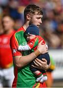 19 September 2021; Rapparees goalkeeper Anthony Larkin carries his son Keegan, age 5 and a half months, in the parade before the Wexford Senior County Hurling Championship Final match between St Anne's Rathangan and Rapparees at Chadwicks Wexford Park in Wexford. Photo by Piaras Ó Mídheach/Sportsfile