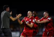 24 September 2021; Michael O'Connor of Shelbourne, second from left, celebrates after scoring his side's second goal with a supporter and team-mates during the SSE Airtricity League First Division match between Cabinteely and Shelbourne at Stradbrook in Blackrock, Dublin. Photo by David Fitzgerald/Sportsfile