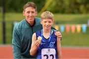 25 September 2021; Oisin Giles from Skyrne, Meath, after winning gold in the Boys under-12 100 metre with his dad former Meath footballer and All-Ireland Winner Trevor Giles during the Aldi Community Games Track and Field Athletics finals at Carlow IT Sports Campus in Carlow. Photo by Matt Browne/Sportsfile