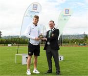 25 September 2021; Gerry McGuinness, President of the Community Games, makes a presentation to Irish 100 metre sprinter Marcus Lawler during the Aldi Community Games Track and Field Athletics finals at Carlow IT Sports Campus in Carlow. Photo by Matt Browne/Sportsfile