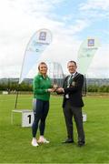 25 September 2021; Gerry McGuinness, President of the Community Games makes a presentation to Irish sprinter Sarah Quinn during the Aldi Community Games Track and Field Athletics finals at Carlow IT Sports Campus in Carlow. Photo by Matt Browne/Sportsfile