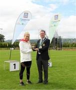 25 September 2021; Gerry McGuinness, President of the Community Games, makes a presentation to Irish sprinter Molly Scott during the Aldi Community Games Track and Field Athletics finals at Carlow IT Sports Campus in Carlow. Photo by Matt Browne/Sportsfile