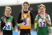 25 September 2021; Nicole Griffin, 5, from Ballynally-Lissycasey, Clare, with her gold medal she won in the Girls under-10 200 metre with third place Holly Mcelarney, left, from Mayo and second place Nicole Rigney, right, from Carlow during the Aldi Community Games Track and Field Athletics finals at Carlow IT Sports Campus in Carlow. Photo by Matt Browne/Sportsfile