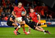 25 September 2021; Dan Goggin of Munster is tackled by Marius Louw of Cell C Sharks during the United Rugby Championship match between Munster and Cell C Sharks at Thomond Park in Limerick. Photo by Seb Daly/Sportsfile