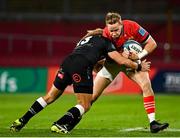 25 September 2021; Mike Haley of Munster is tackled by Werner Kok of Cell C Sharks during the United Rugby Championship match between Munster and Cell C Sharks at Thomond Park in Limerick. Photo by Seb Daly/Sportsfile