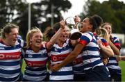 26 September 2021; Blackrock College captain Valerie Power celebrates with the trophy and team-mates including Eimear Corri, right, after the Bank of Ireland Paul Flood cup final match between Blackrock College RFC J1 and Old Belvedere RFC J1 at Old Belvedere RFC in Anglesea Road, Dublin. Photo by Harry Murphy/Sportsfile