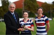26 September 2021; President of Leinster Rugby John Walsh presents the MVP award to Roisin Crowe of Blackrock College with captain Valerie Power after the Bank of Ireland Paul Flood cup final match between Blackrock College RFC J1 and Old Belvedere RFC J1 at Old Belvedere RFC in Anglesea Road, Dublin. Photo by Harry Murphy/Sportsfile