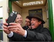 30 September 2021; Jockey Frankie Dettori, with fellow jockeys Jamie Spencer, left, and Shane Kelly, takes a selfie in the famous Barney Curley phone box, associated with the Yellow Sam coup in 1975, before the Gannon City Recovery and Recycling Services Ltd supporting DAFA handicap at Bellewstown Racecourse in Collierstown, Meath. Photo by Matt Browne/Sportsfile