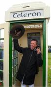 30 September 2021; Jockey Frankie Dettori, with the hat of the late trainer Barney Curley in the famous phone box, associated with the Yellow Sam coup in 1975, before the Gannon City Recovery and Recycling Services Ltd supporting DAFA handicap at Bellewstown Racecourse in Collierstown, Meath. Photo by Matt Browne/Sportsfile