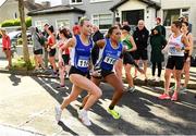 3 October 2021; Jodie McCann of Dublin City Harriers AC, left, hands over to team-mate Nadia Power during the Senior Women's race at the Irish Life Health Road Relay Championships in Raheny, Dublin. Photo by Seb Daly/Sportsfile
