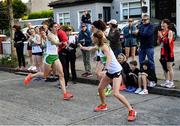 3 October 2021; Kate Purcell of Raheny Shamrock AC, left, hands over to team-mate Sarah Quigley during the Women's Masters race at the Irish Life Health Road Relay Championships in Raheny, Dublin. Photo by Seb Daly/Sportsfile