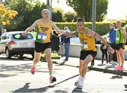 3 October 2021; Ian O'Reilly of Brothers Pearse AC, left, hands over to team-mate Anthony O'Rourke during the Men's Masters race at the Irish Life Health Road Relay Championships in Raheny, Dublin. Photo by Seb Daly/Sportsfile