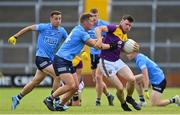 4 July 2021; Tom Byrne of Wexford in action against Ciarán Kilkenny of Dublin during the Leinster GAA Football Senior Championship Quarter-Final match between Wexford and Dublin at Chadwicks Wexford Park in Wexford. Photo by Brendan Moran/Sportsfile