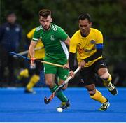 5 October 2021; Marhan Jalil of Malaysia in action against John McKee of Ireland during an international friendly match between Ireland and Malaysia at Lisnagarvey Hockey Club in Hillsborough, Down. Photo by Ramsey Cardy/Sportsfile