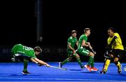 5 October 2021; Lee Cole of Ireland strikes the ball from a penalty corner under pressure from Marhan Jalil of Malaysia during an international friendly match between Ireland and Malaysia at Lisnagarvey Hockey Club in Hillsborough, Down. Photo by Ramsey Cardy/Sportsfile