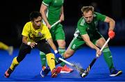 5 October 2021; Luke Madeley of Ireland in action against Faiz Jali of Malaysia during an international friendly match between Ireland and Malaysia at Lisnagarvey Hockey Club in Hillsborough, Down. Photo by Ramsey Cardy/Sportsfile
